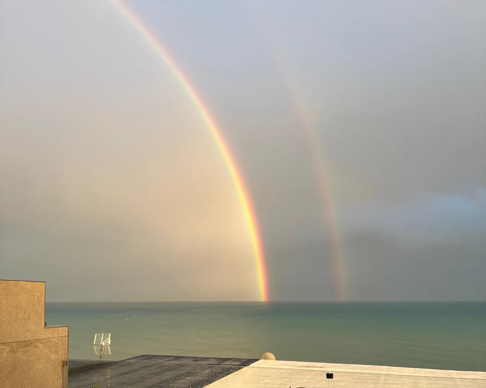 A double rainbow over the sea, seen from the terrace
